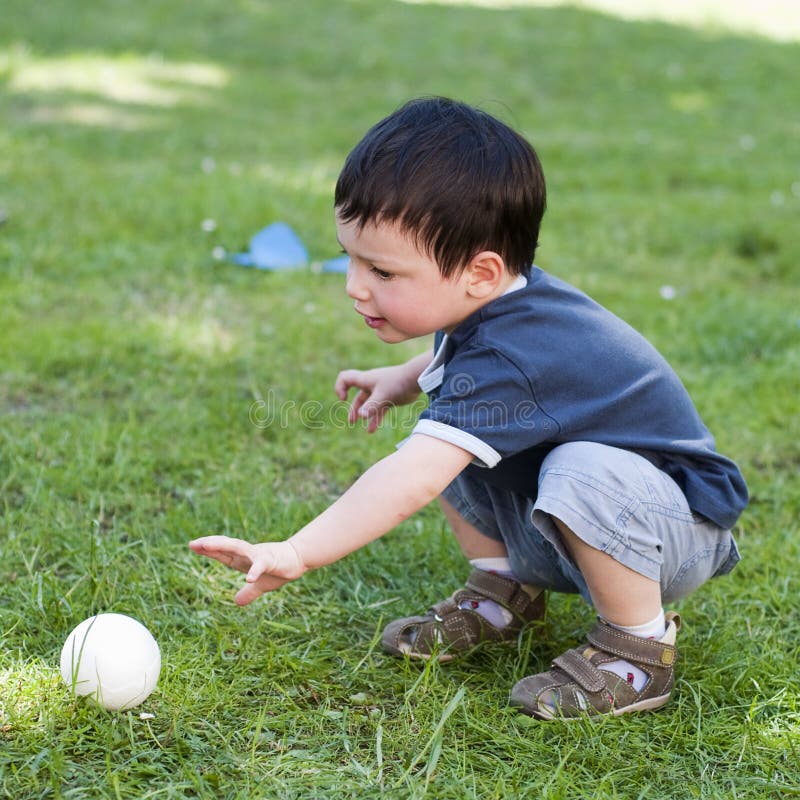 Child with ball in garden