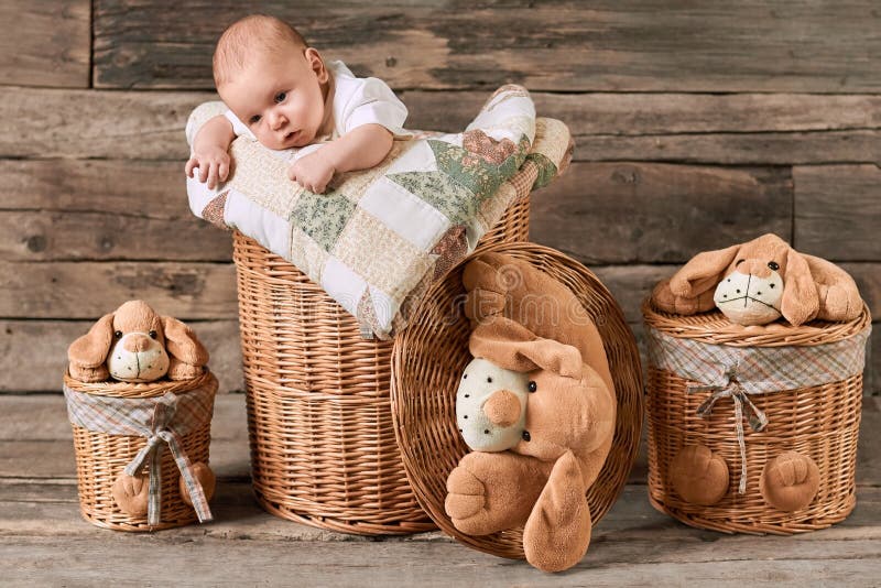 Child and baskets, wooden background.