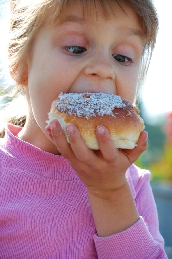 Child biting a doughnut