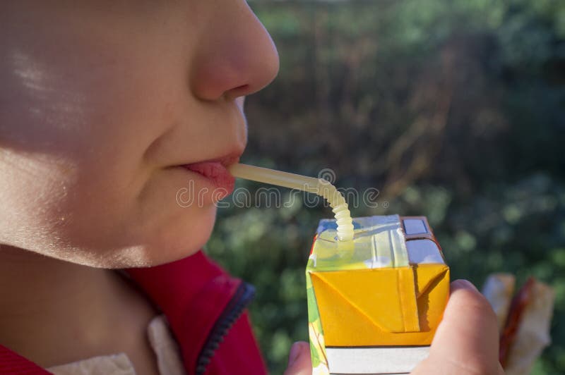 Child Boy Drinking Sweetened Juice Fruit Juice from Brick Stock Image
