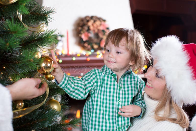 Child boy helps mother and father to decorate royalty free stock photography Child boy helps mother and father to decorate royalty free stock photography