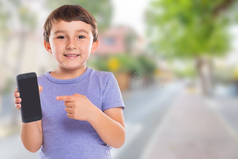 Child boy pointing at smartphone smart cell phone cellphone town copyspace copy space marketing ad advertising