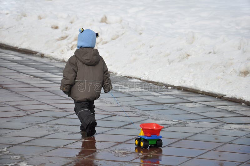 A child carries a plastic trimmer