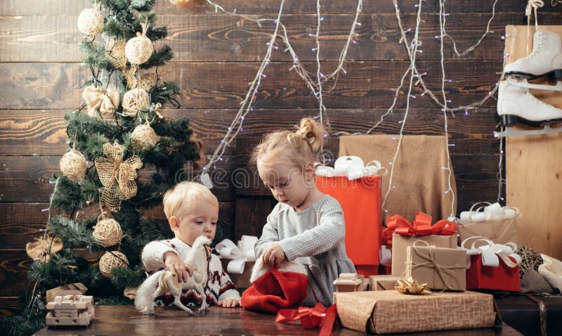 Child with a Christmas present on wooden background. Winter kids. Kid enjoy the holiday. Christmas card. New year kids. Happy child with christmas gift box royalty free stock photo Child with a Christmas present on wooden background. Winter kids. Kid enjoy the holiday. Christmas card. New year kids. Happy child with christmas gift box royalty free stock photo