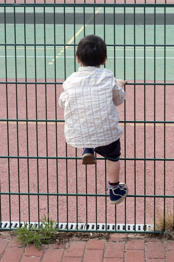 Child climbing fence