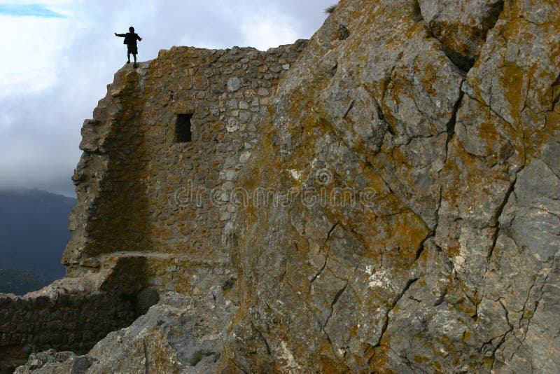 A child climbing on a hight rock wall