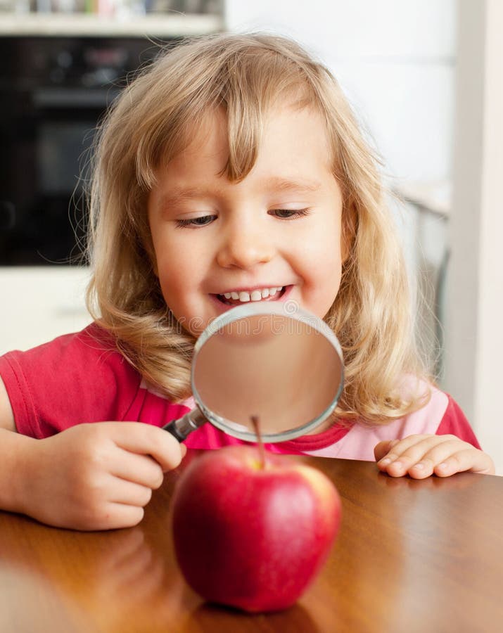 Child are Considering a Magnifying Glass Apple Stock Image Image of