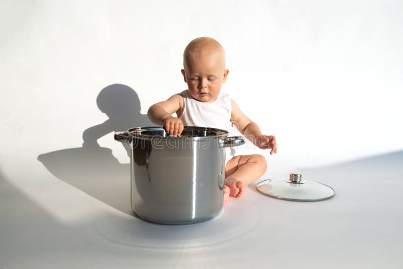 baby with big cooking pot Stock Photo
