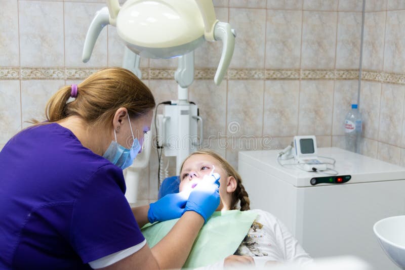 A Child at a Dentist`s Appointment in a Dental Clinic. Editorial Stock
