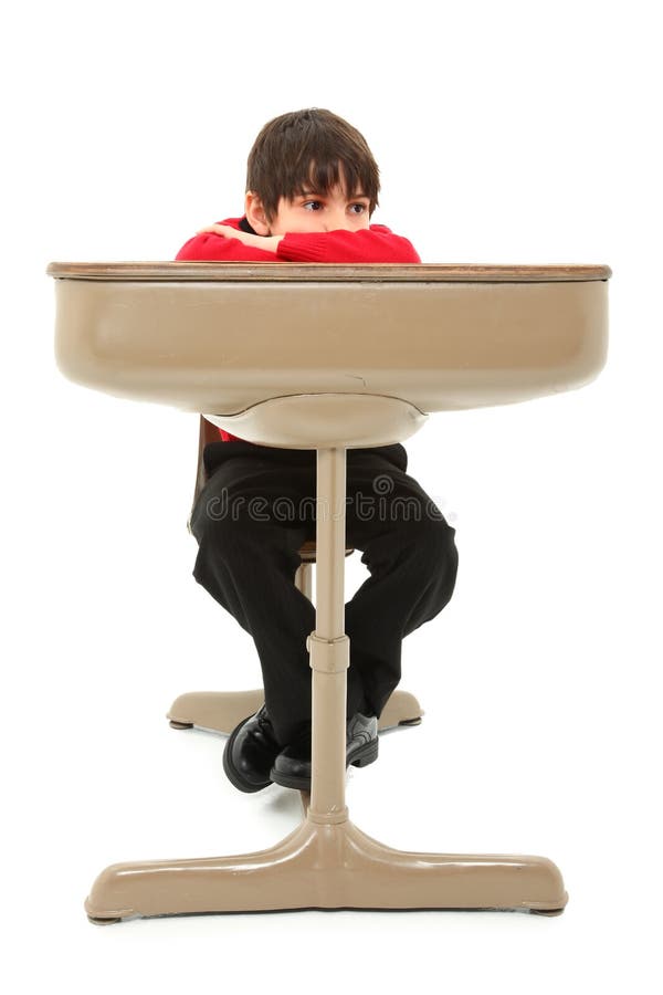 Attractive 7 year old french american boy in school desk over white. Boring kid white stock images, royalty-free photos and pictures