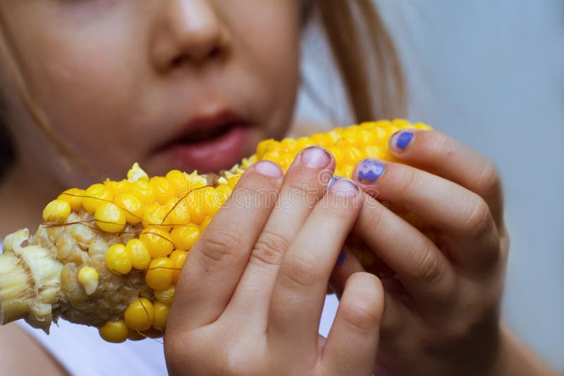 Child Eating Corn On The Cob Stock Image - Image of person, touch: 20579471