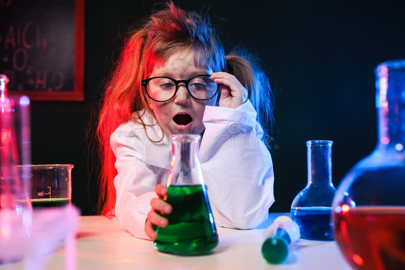 Child doing chemical research in laboratory. Dangerous experiment. Child doing chemical research in laboratory. Dangerous experiment