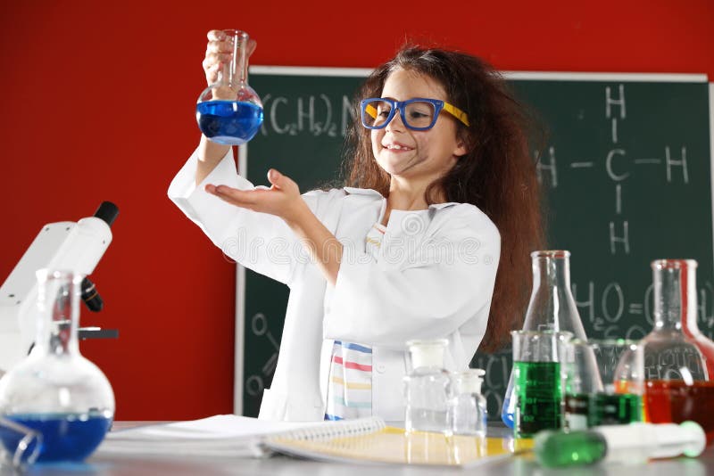 Child doing chemical research in laboratory. Dangerous experiment. Child doing chemical research in laboratory. Dangerous experiment