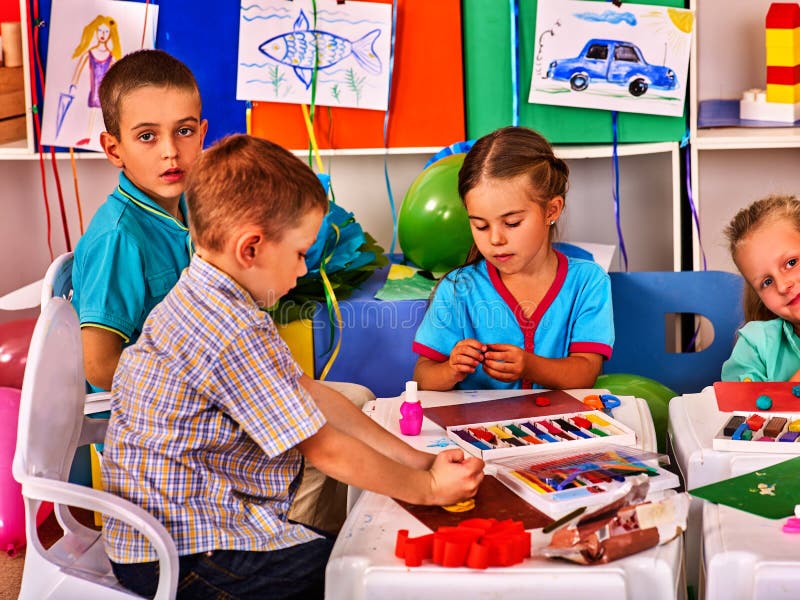 Plasticine Modeling Clay In Children Class. Teacher Teaches Kids Together  Play Dough And Mold From Plasticine In Kindergarten Or Preschool. Group Of  Four People. Zoo From The Clay. Stock Photo, Picture and