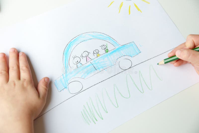 Close-up of childs hands drawing a blue car with a family in it. Close-up of childs hands drawing a blue car with a family in it