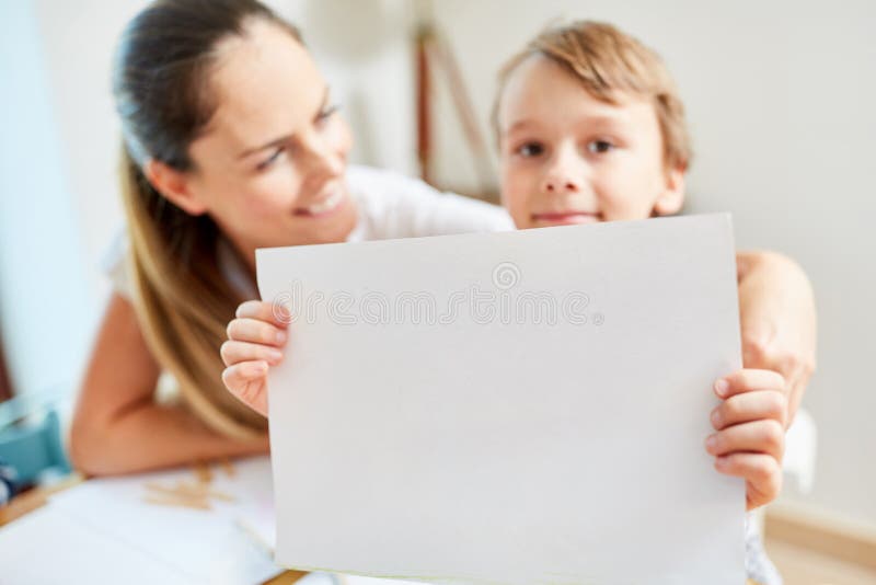 Child with drawing of the dream house as wish for the family before the move. Child with drawing of the dream house as wish for the family before the move