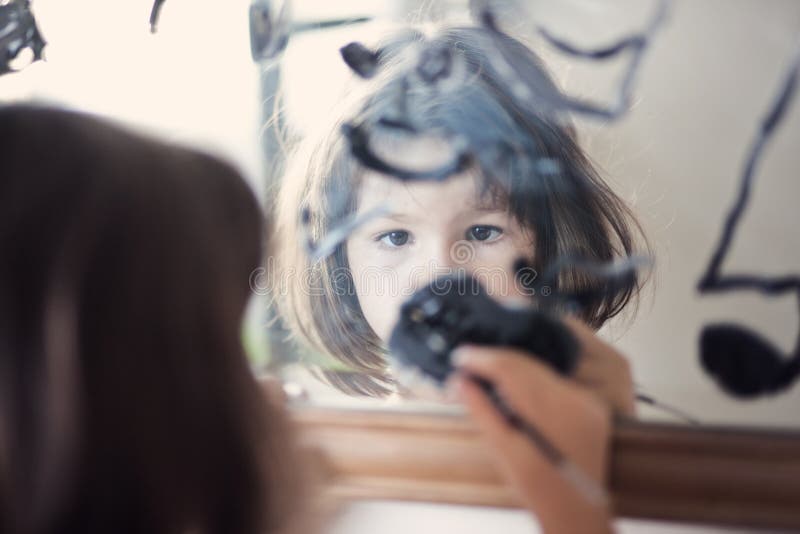 Child draws on the mirror