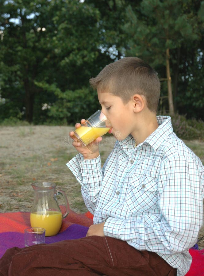 Child drinking juice stock image. Image of orange, tree 11516495