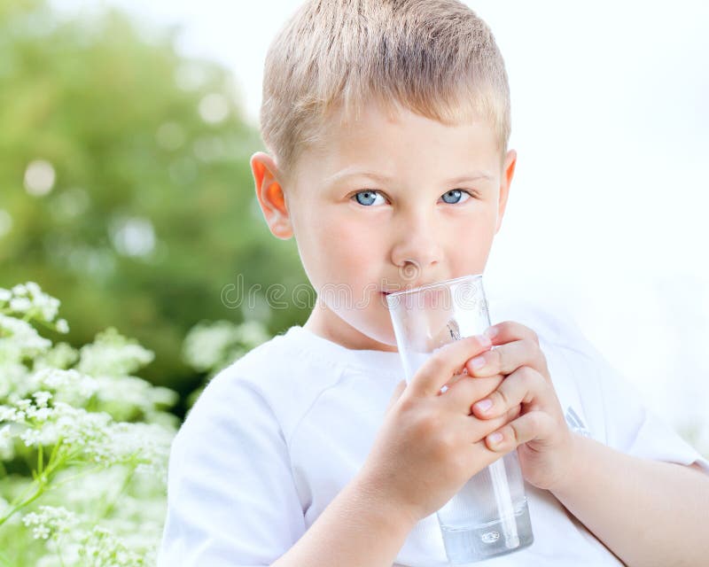 Child drinking pure water in nature
