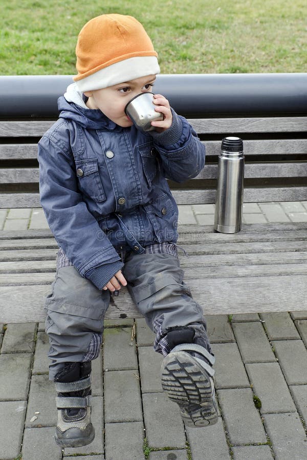 Child drinking tea from flask. royalty free stock photography Child drinking tea from flask. royalty free stock photography