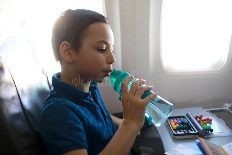 Child Drinking Water in Plane Stock Image Image of chair, fresh