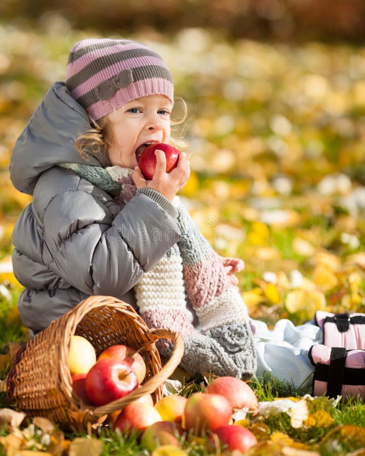 Child eating apple stock photo. Image of blurred, grass 25262728