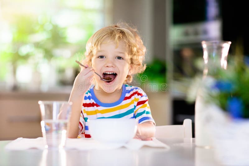 Child Eating Breakfast. Kid with Milk and Cereal Stock Image - Image of ...