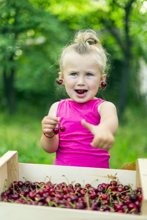 Child eating cherries stock photo. Image of cheerful 42630888