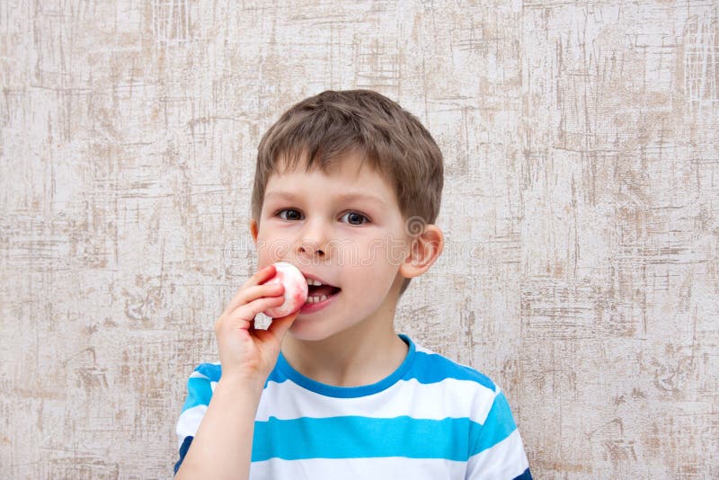 Child Eating an Easter Egg. Festive Easter Breakfast. Portrait of Cute