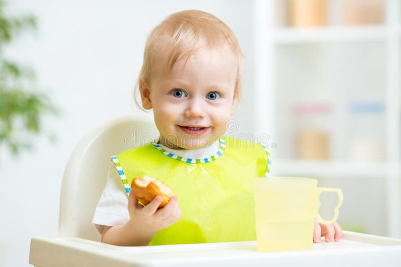 Child eating food in highchair