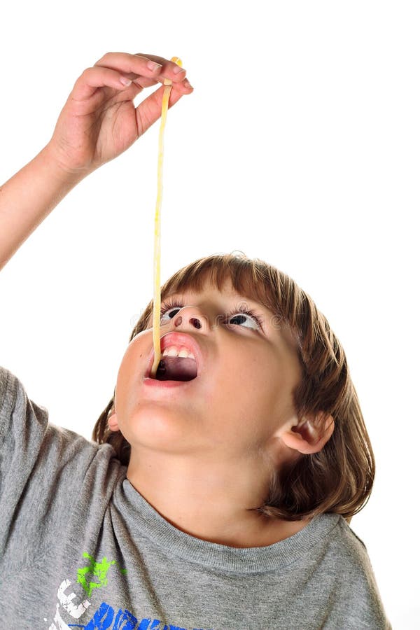 Child eating pasta noodle