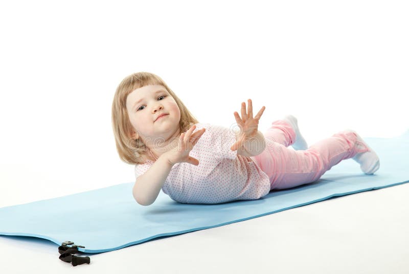 Child Exercising Lying on a Training Mat Stock Image Image of small