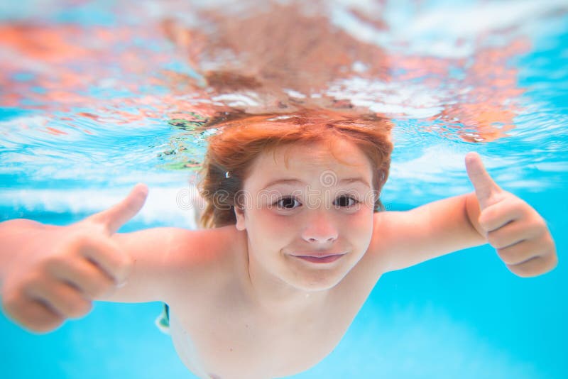 Child Face Underwater with Thumbs Up. Kid Swimming in Pool Underwater ...