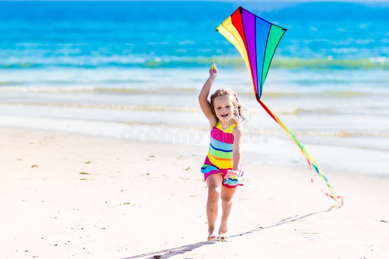 Child flying kite on tropical beach