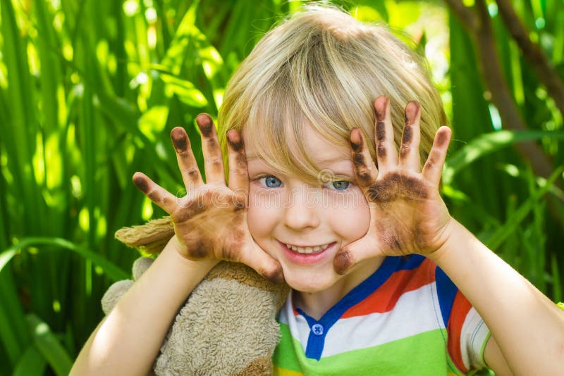 Child in garden with dirty hands