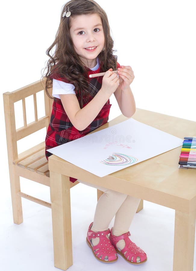 Child girl drawing with colourful pencils