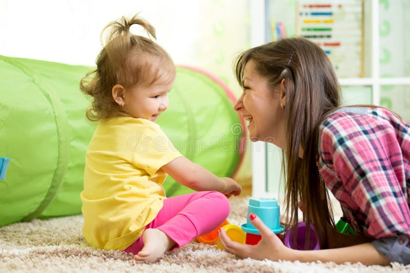 Child girl and her mother playing together with toys royalty free stock image Child girl and her mother playing together with toys royalty free stock image