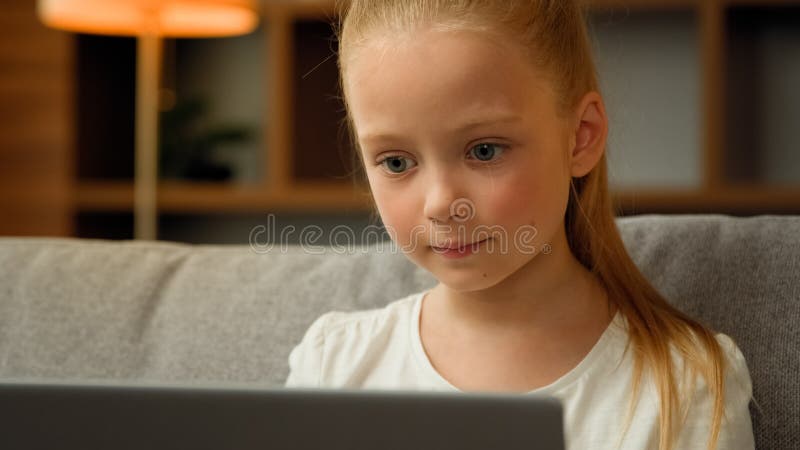 Young girl playing video games on computer after online school Stock Photo  by DC_Studio