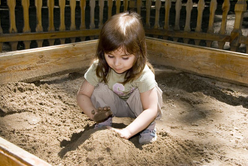 Child girl plaing at sand-box stock photo Child girl plaing at sand-box stock photo