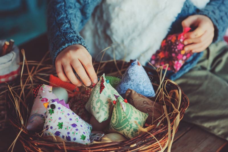 Child girl playing with easter eggs and handmade decorations in cozy country house