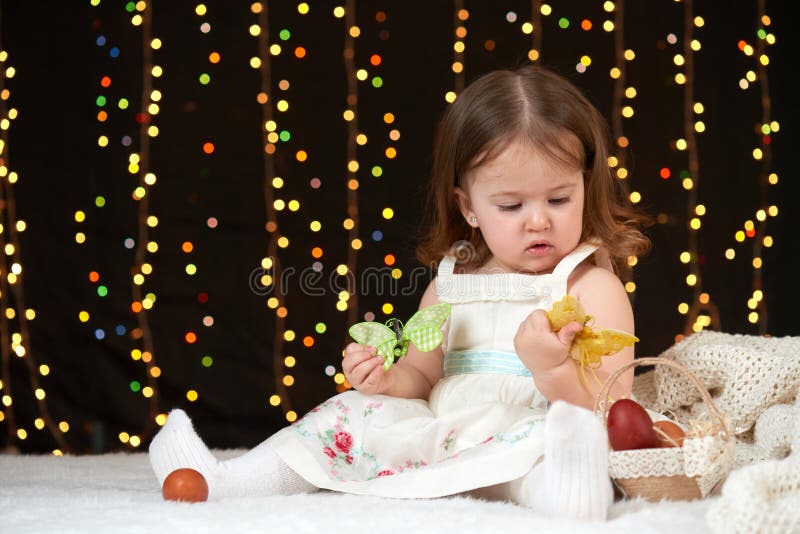 Child girl portrait in christmas decoration, happy emotions, winter holiday concept, dark background with illumination and boke li stock photo Child girl portrait in christmas decoration, happy emotions, winter holiday concept, dark background with illumination and boke li stock photo
