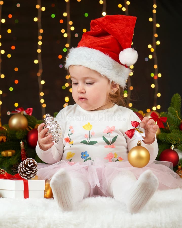 Child girl portrait in christmas decoration, happy emotions, winter holiday concept, dark background with illumination and boke li royalty free stock photography Child girl portrait in christmas decoration, happy emotions, winter holiday concept, dark background with illumination and boke li royalty free stock photography