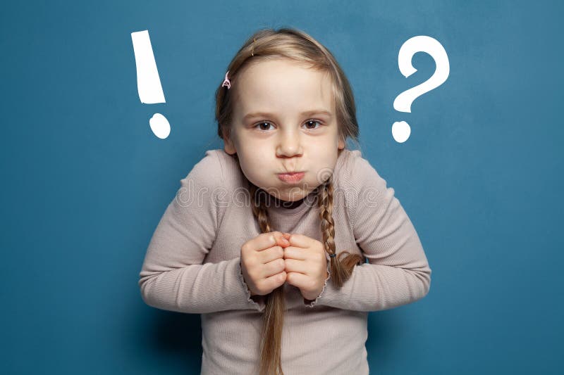 Child Girl with Question and Exclamation Marks on the Background of