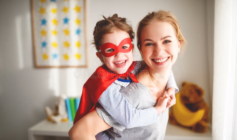 Child girl in a super hero costume with mask and red cloak royalty free stock photography Child girl in a super hero costume with mask and red cloak royalty free stock photography