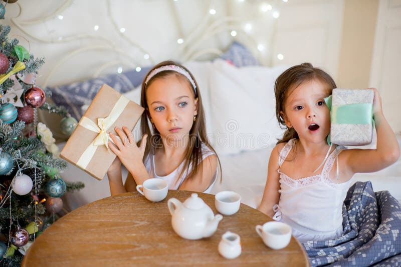 Child girls wake up in her bed in Christmas morning