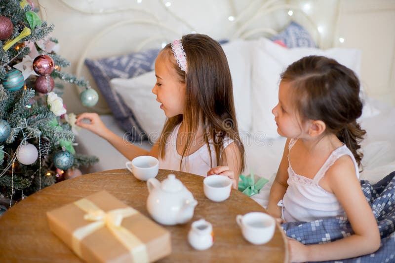 Child girls wake up in her bed in Christmas morning