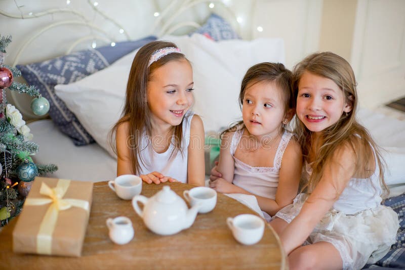 Child girls wake up in her bed in Christmas morning