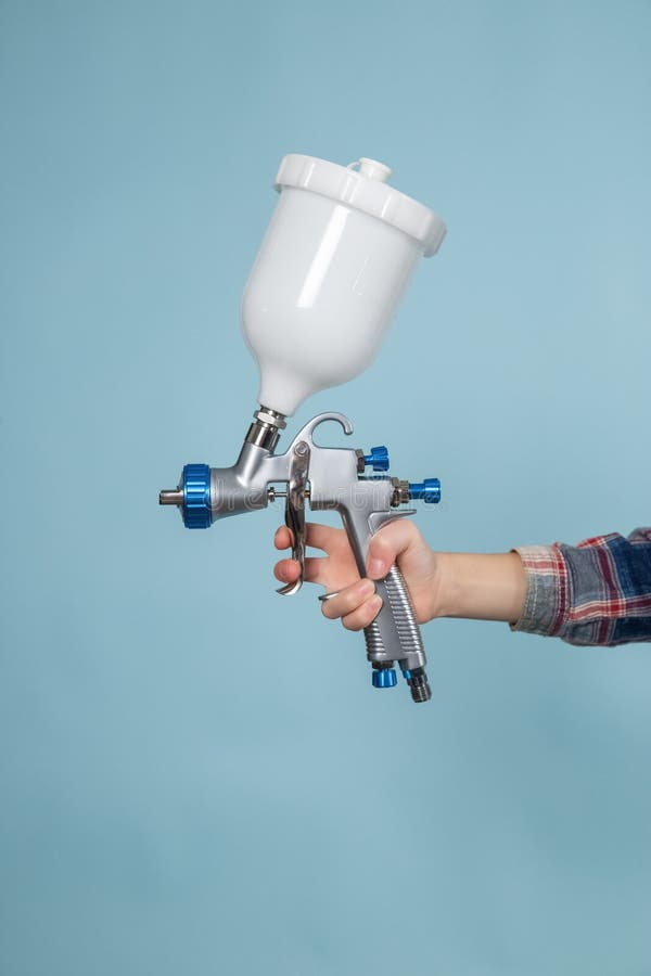 Child Hand with Electric Spray Gun, Painter or Decorator Concept. Stock Photo Image of happy