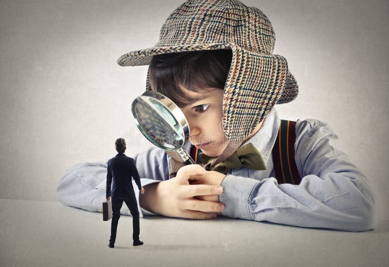 Child with a hand lens looking at a businessman stock images Child with a hand lens looking at a businessman stock images