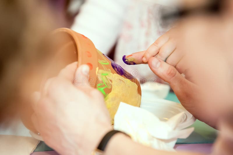 Child hand parent hand painting stock image Child hand parent hand painting stock image